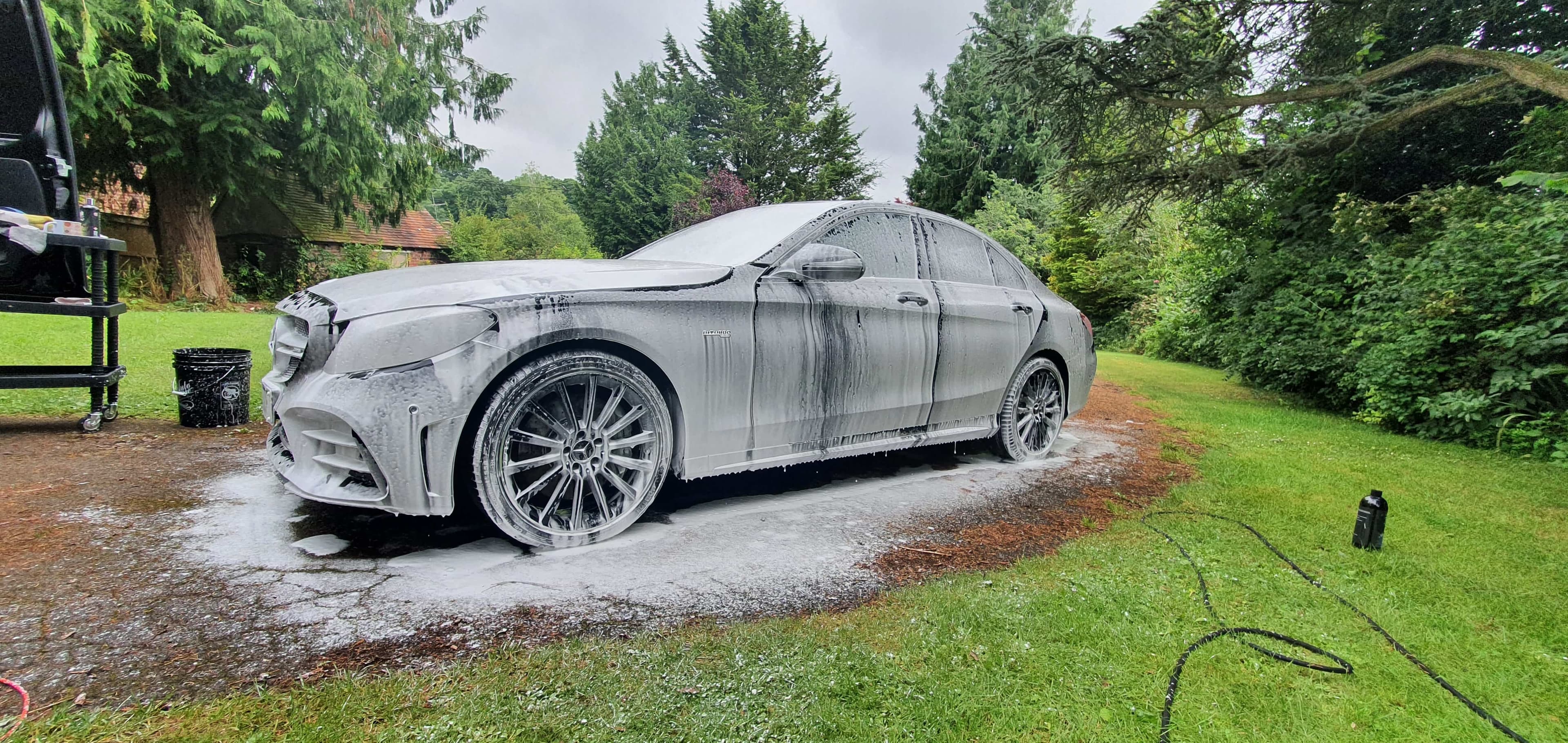 A Mercedes Benz Covered in snow foam